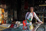A Man in White Long Sleeves Standing Inside the Store Full of Accessories