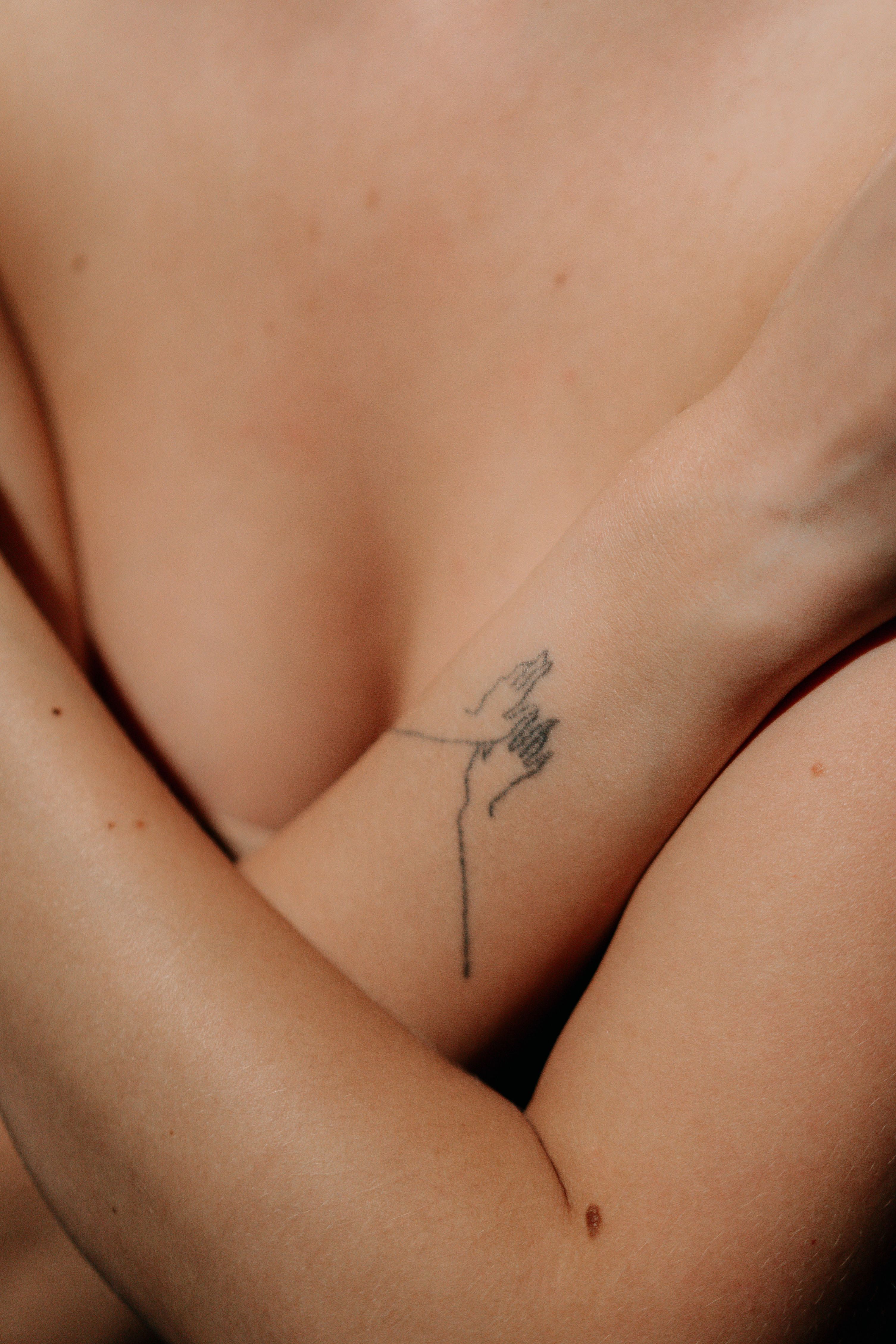 Delicate fine line tattoo on arm