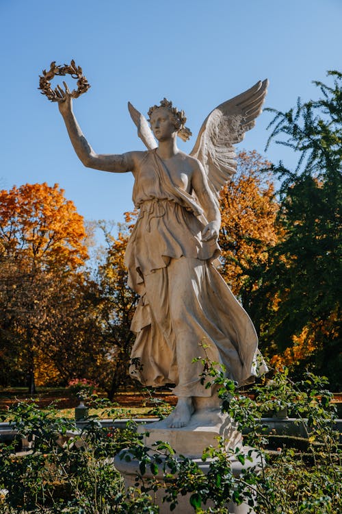 Free Angel Statue Near Green and Brown Trees Stock Photo