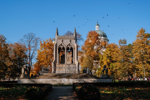 Capture of the historic Potocki Mausoleum surrounded by vibrant autumn foliage in Wilanów Park, Warsaw.