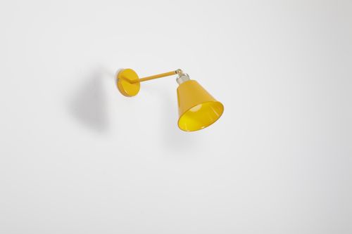 Free A sleek yellow wall lamp mounted on a plain white wall, perfect for modern decor. Stock Photo