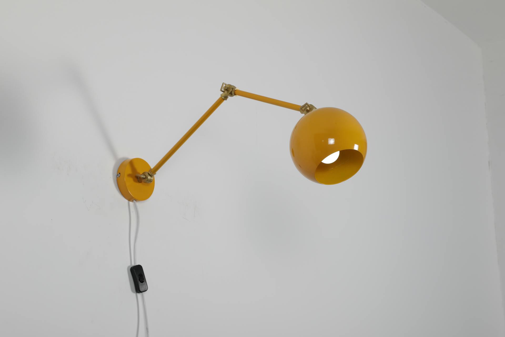 A Yellow Lamp Mounted on White Wall