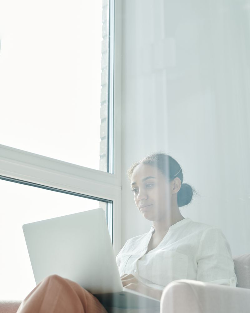 Product builder working by a window, photographed by Tiger Lily on Pexels
