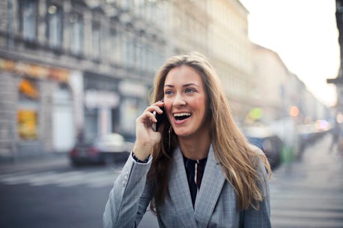 Free Blonde Hair Woman Wearing Gray Suit Jacket Holding Smartphone Stock Photo
