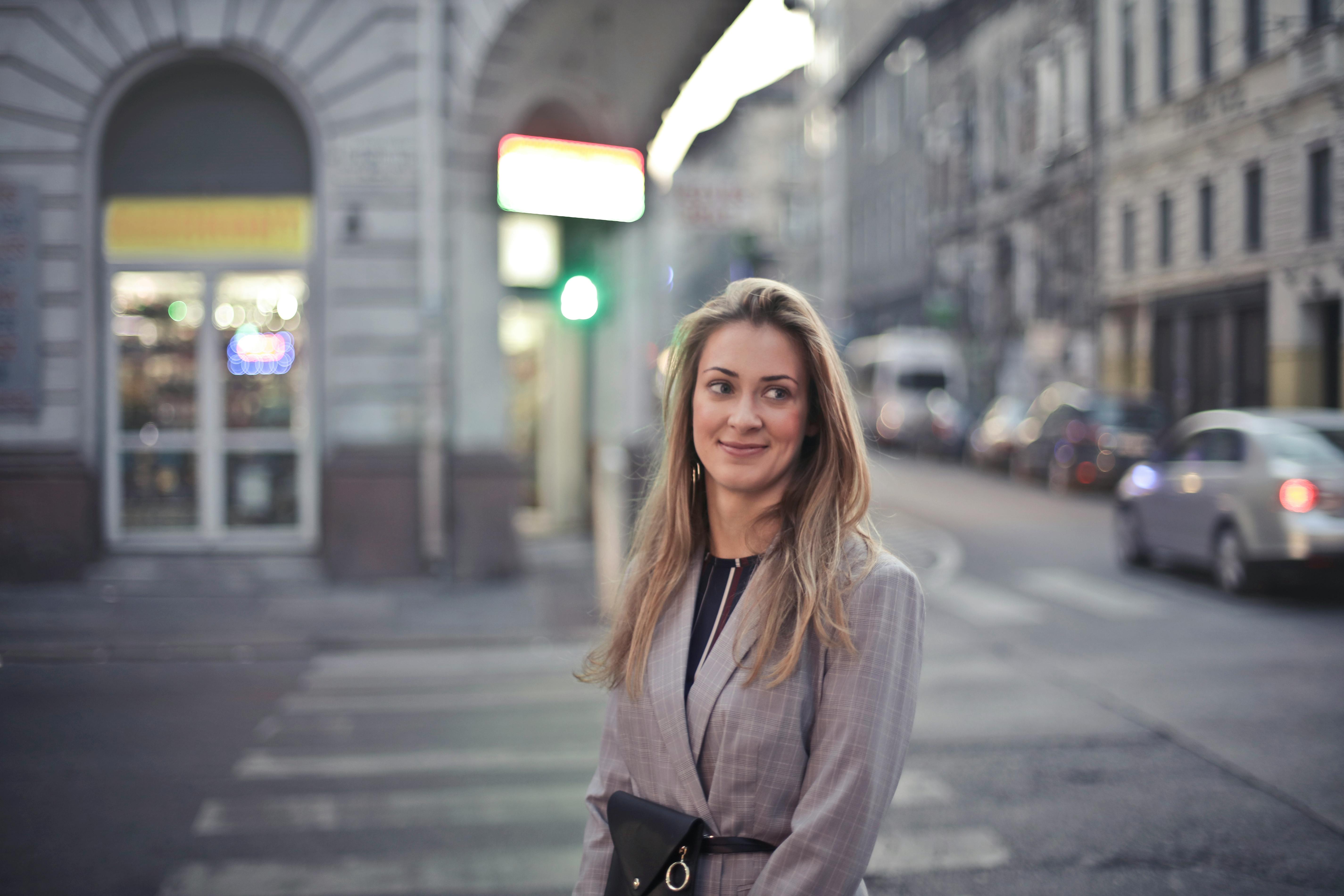 woman in gray suit jacket near gray car