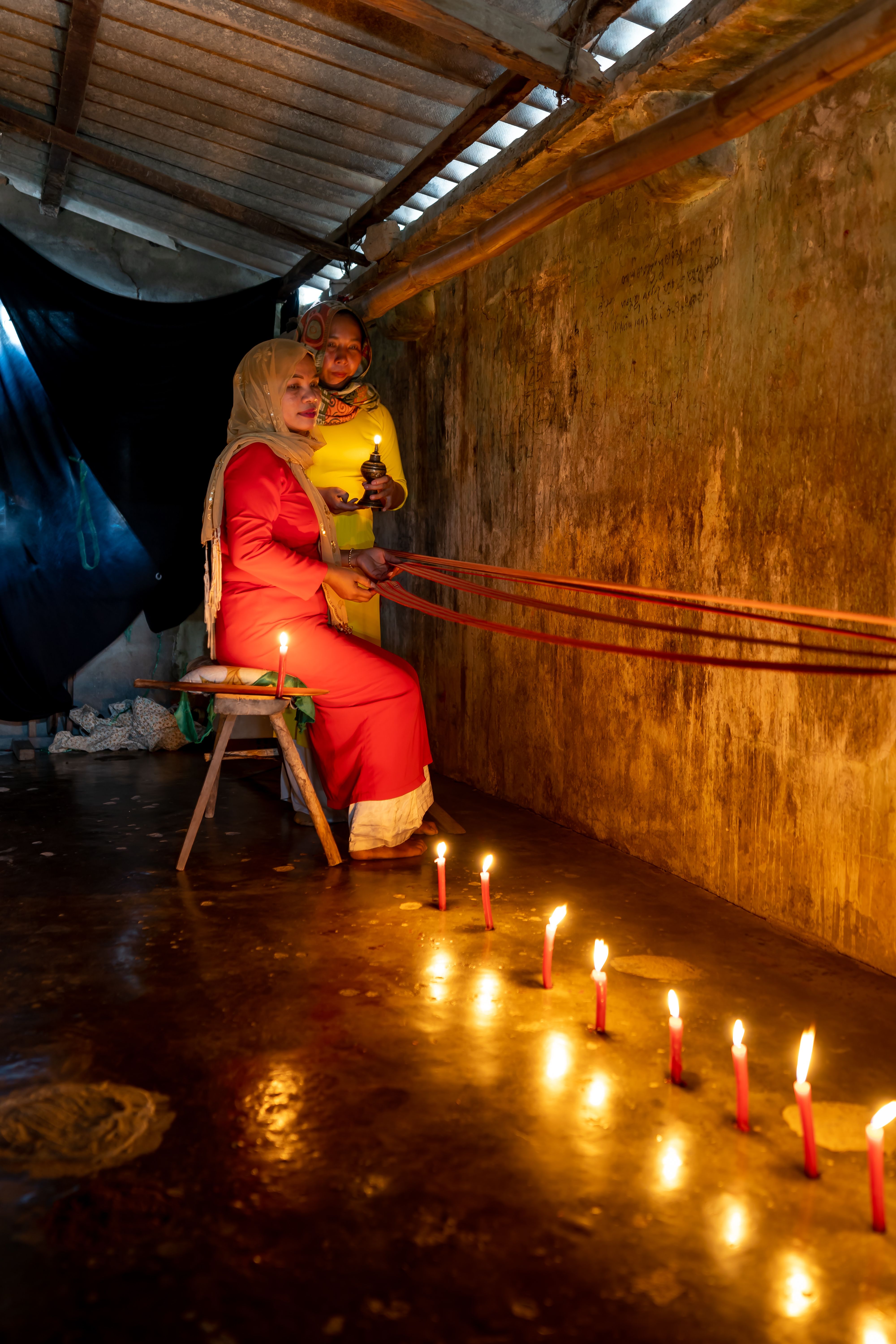 Person Holding a Rope Beside Lighted Candles · Free Stock Photo