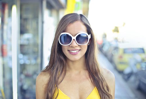 Free Woman Wearing Yellow Spaghetti Strap Top and Round Sunglasses Stock Photo