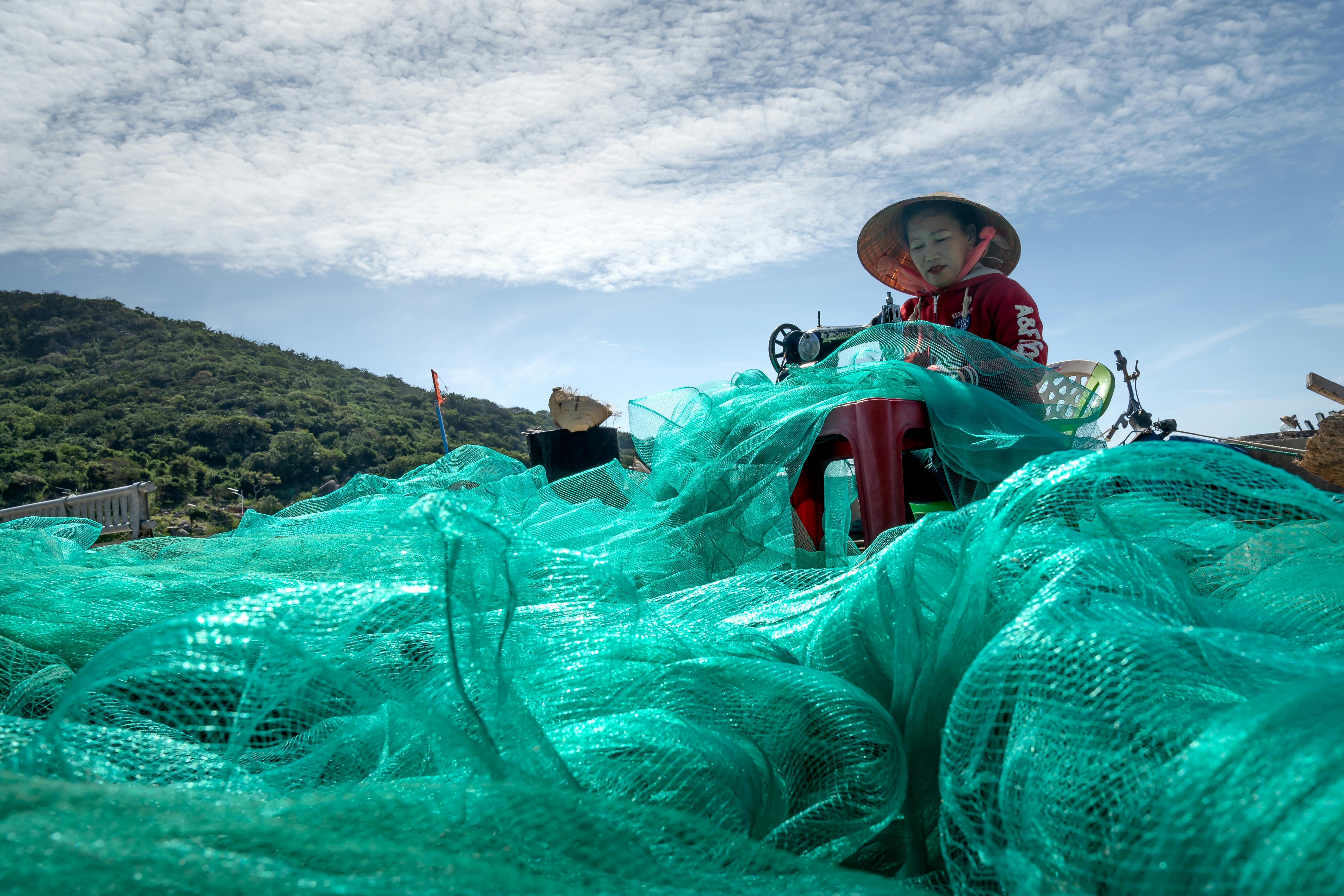 Vietnamese Woman Sewing a Fishing Net · Free Stock Photo