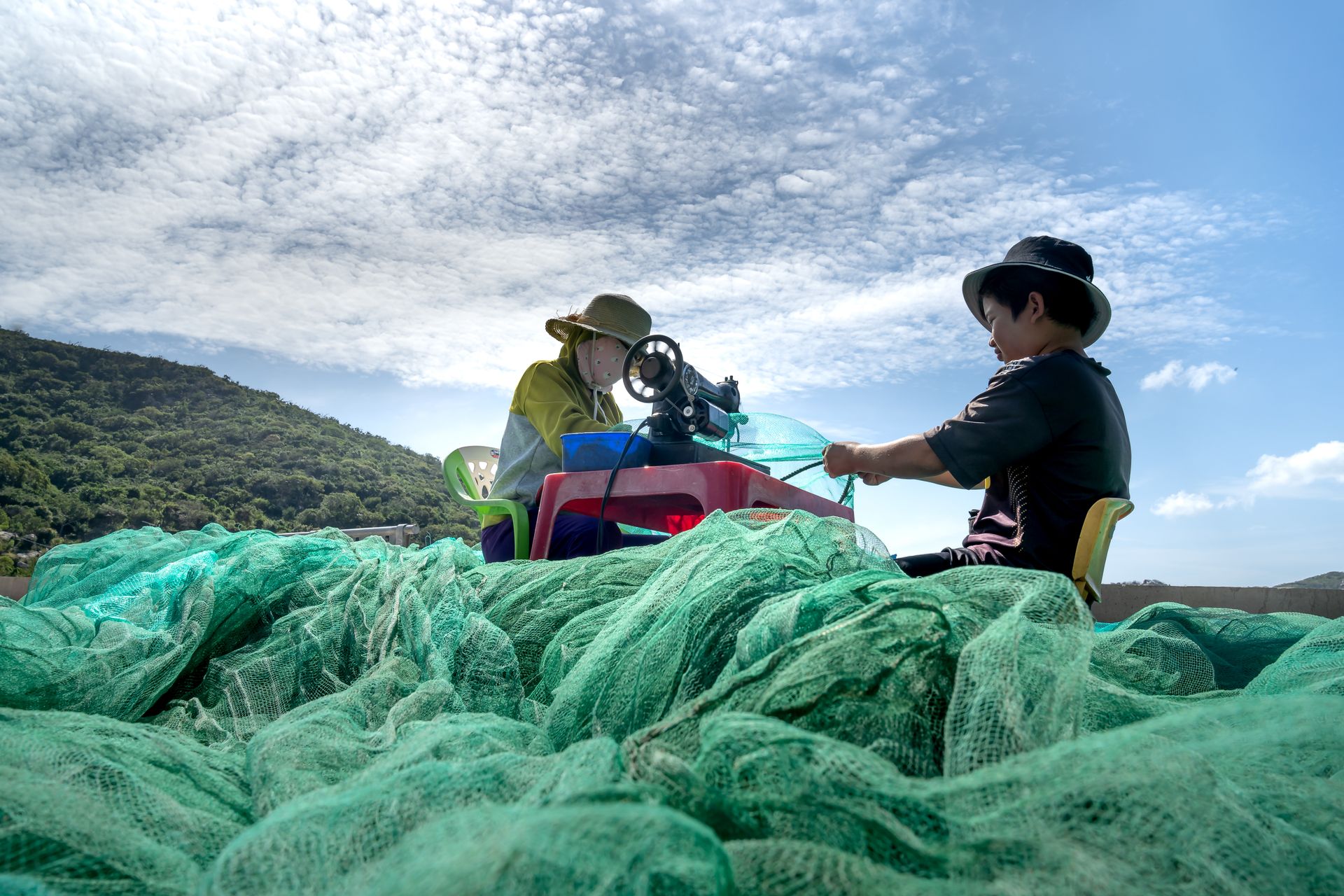 Person Sewing Fishing Nets