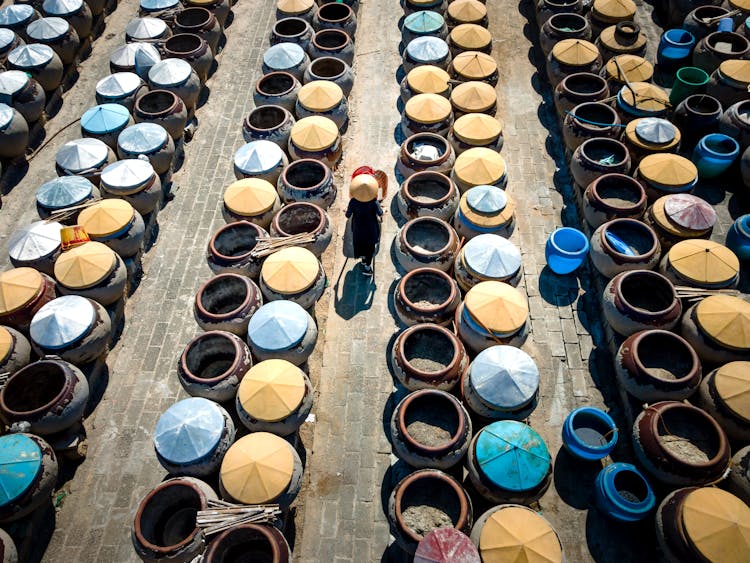 Worker Walking Among Barrels