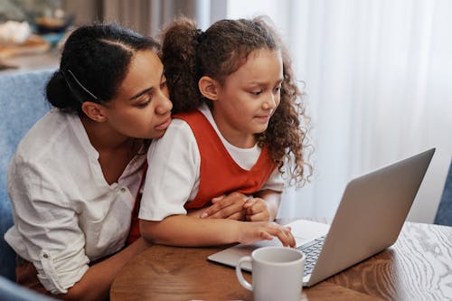 Free A Mother and Her Daughter Looking at a Laptop Stock Photo