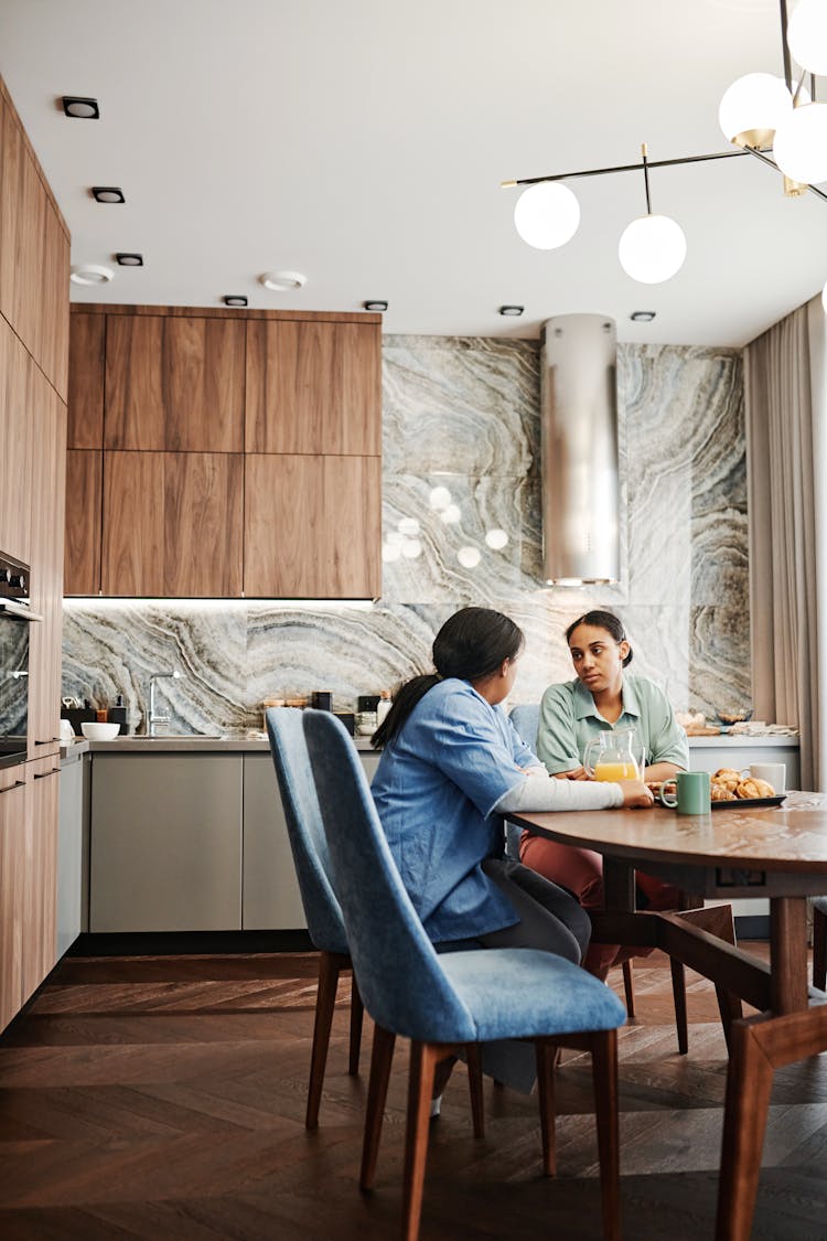 Couple Sitting At Table In Kitchen