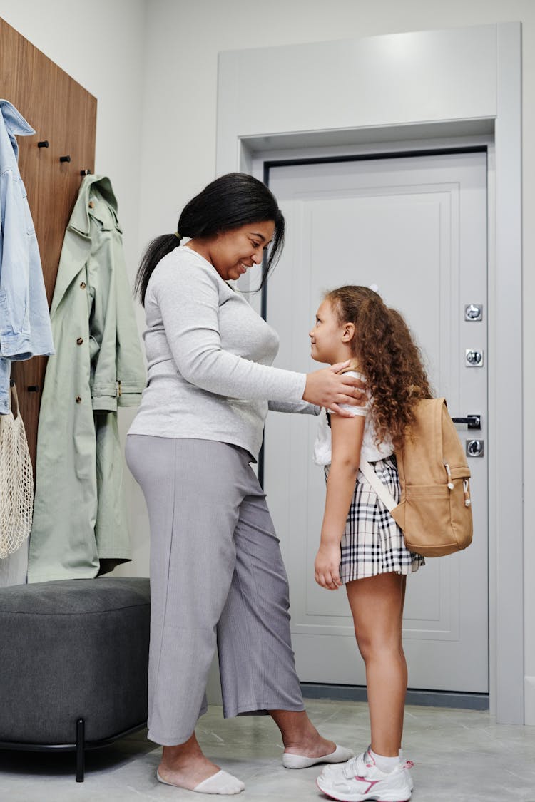 A Smiling Woman Talking To Her Daughter