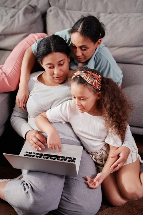 Free A Happy Family Having Conversation while Looking at the Laptop Stock Photo