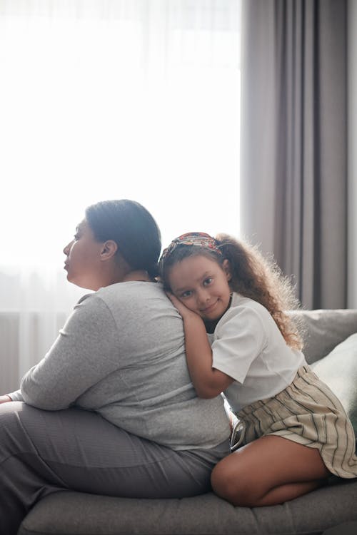 A Young Girl Embracing a Woman