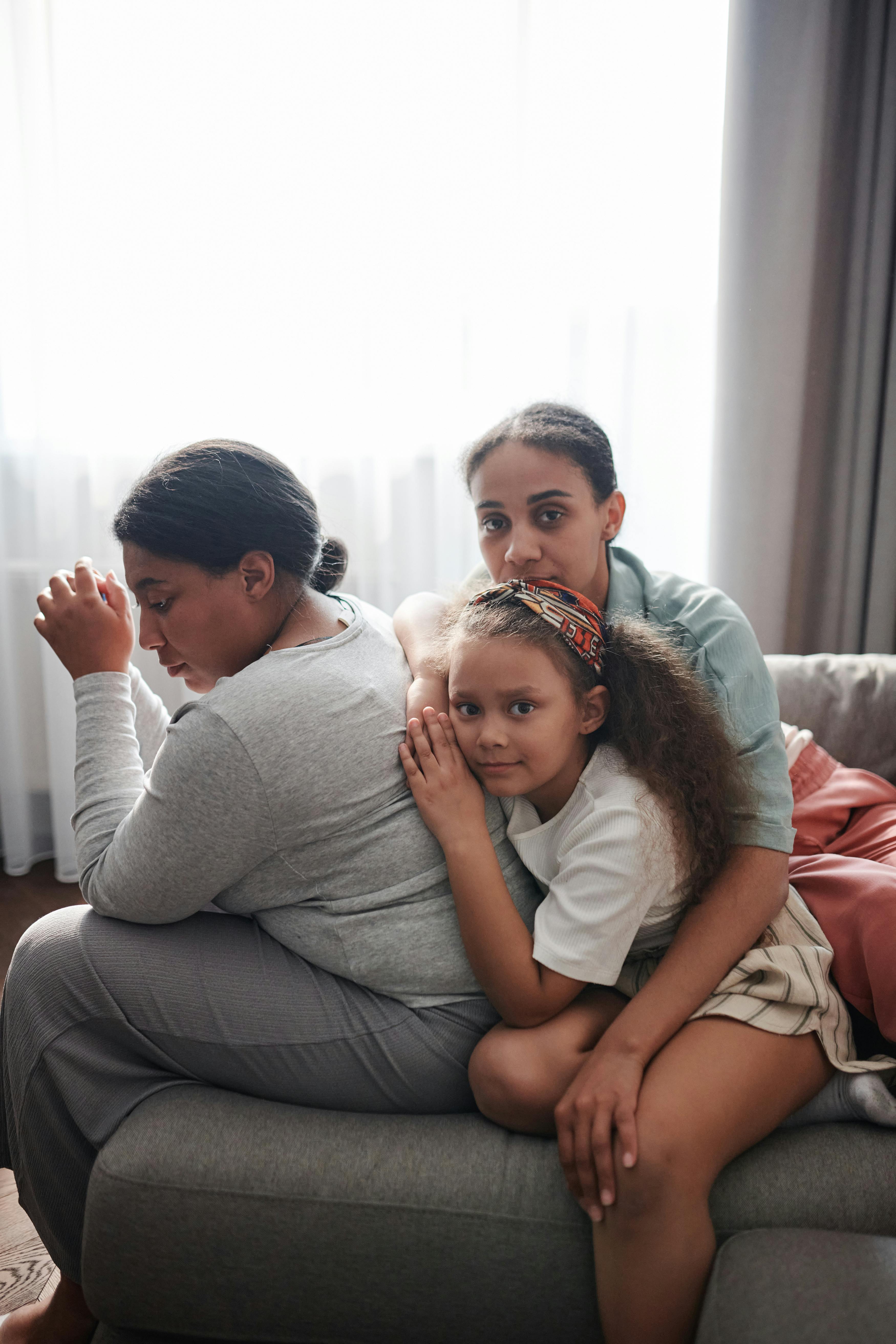 a family sitting on the couch