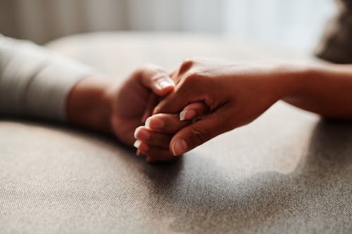 Free Close-Up Shot of Holding Hands Stock Photo