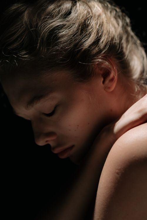 Free A dramatic portrait of a woman with closed eyes, highlighting concepts of introspection and emotional depth. Stock Photo