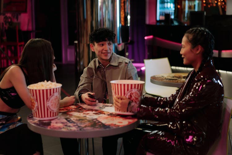 Friends With Popcorn In Cinema Bar