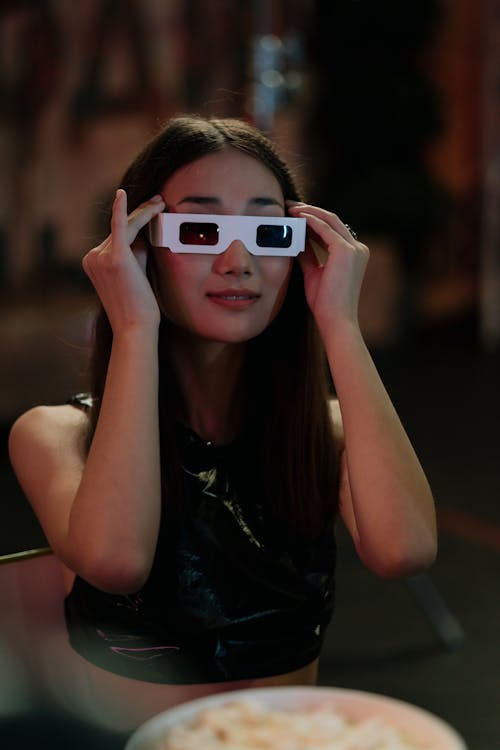 A Woman Putting on 3d Glasses