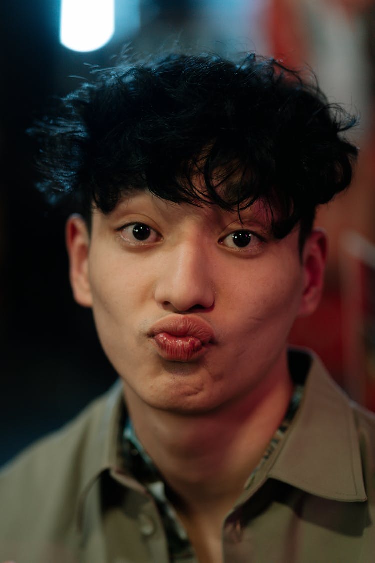 A Man Making Funny Face By Pouting His Lips