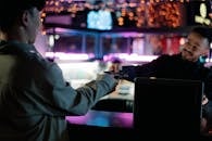 Person in White Long Sleeve Shirt Holding Black Laptop Computer