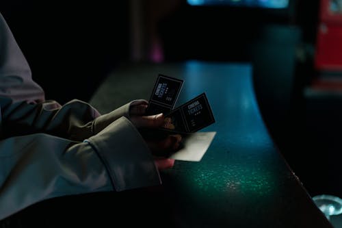 Selective Focus Photo of a Person Holding Three Cinema Tickets