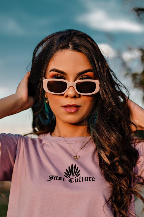 Free Woman in Lavender Crew Neck Shirt Wearing Sunglasses Stock Photo