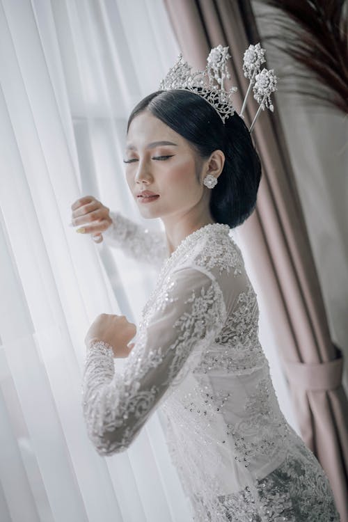 Woman Wearing a White Lace Long Sleeve Dress Holding a Curtain · Free ...