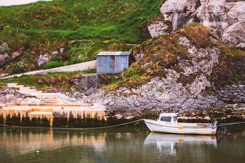 Boat on Body of Water Near Mountain 