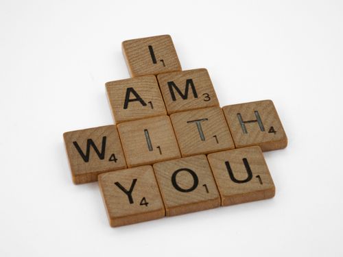 Free Scrabble tiles spelling 'I am with you' on a white background. Stock Photo