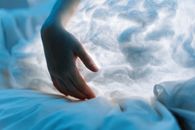 Persons Hand on White Textile