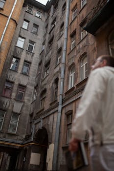 Low angle view of a person exploring old urban architecture in vintage style.