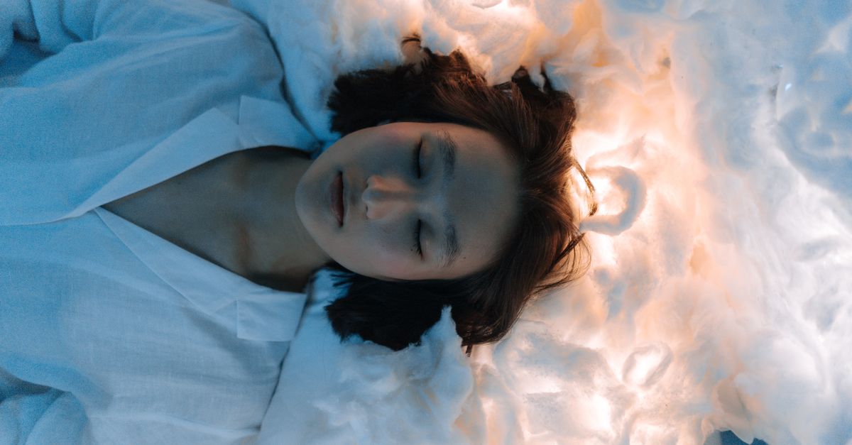 Tranquil portrait of a woman lying peacefully on cloud-like surroundings, evoking calmness. - Evidence evidence guide for melatonin vs l-theanine sleep