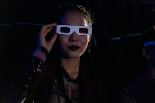 A woman in a dark cinema wearing 3D glasses, enjoying an immersive movie experience.