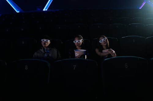 Free Man and Women at a Movie Theater Stock Photo