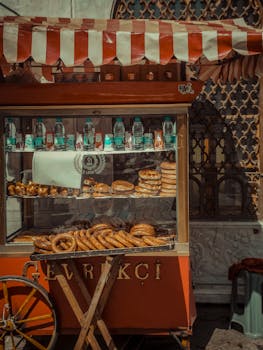 Assorted tasty baked bread and bottles of water placed on shelves in food truck