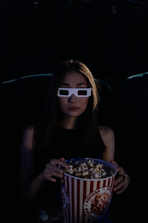 Woman Holding a Bucket of Popcorn