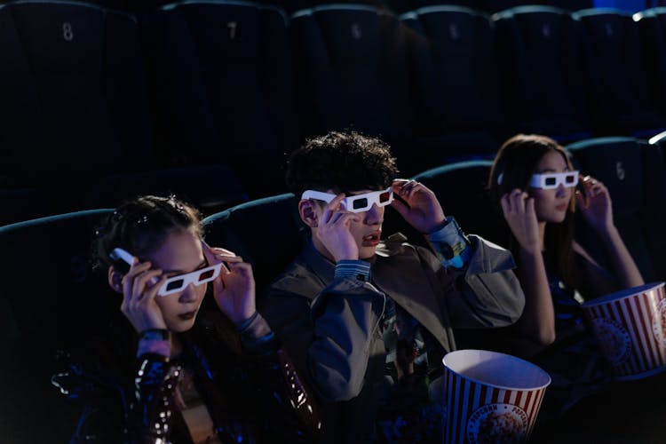 Group Of Friends Wearing 3d Glasses While Watching A Movie