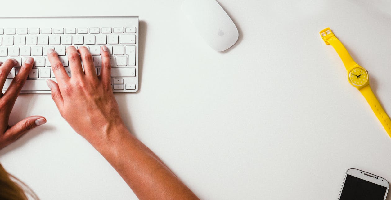 Person Holding Apple Keyboard