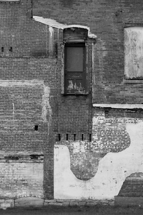 Grayscale Photo of a Brick Building