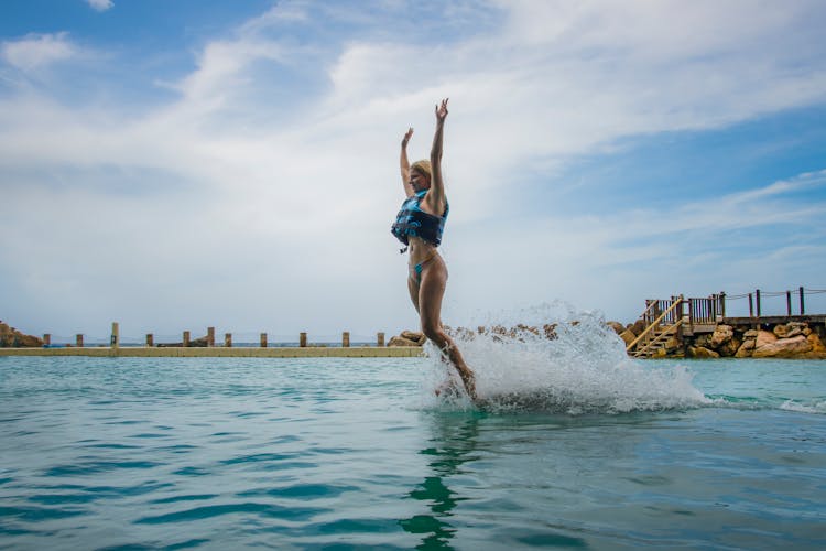 A Woman Jumping On The Water