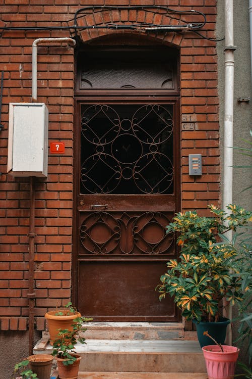 A Metal Door Near the Brick Wall