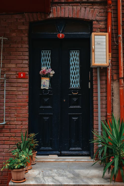 Free A Black Wooden Door of a Building Stock Photo