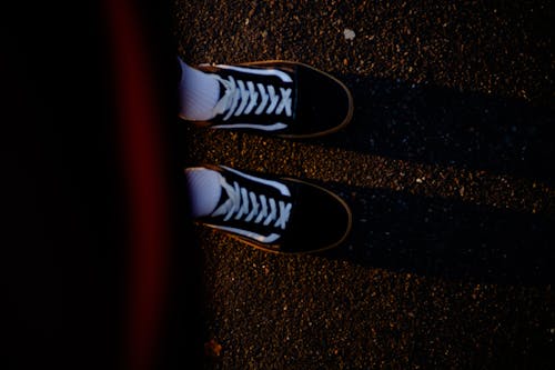 Free Photograph of a Person Wearing Black and White Sneakers Stock Photo