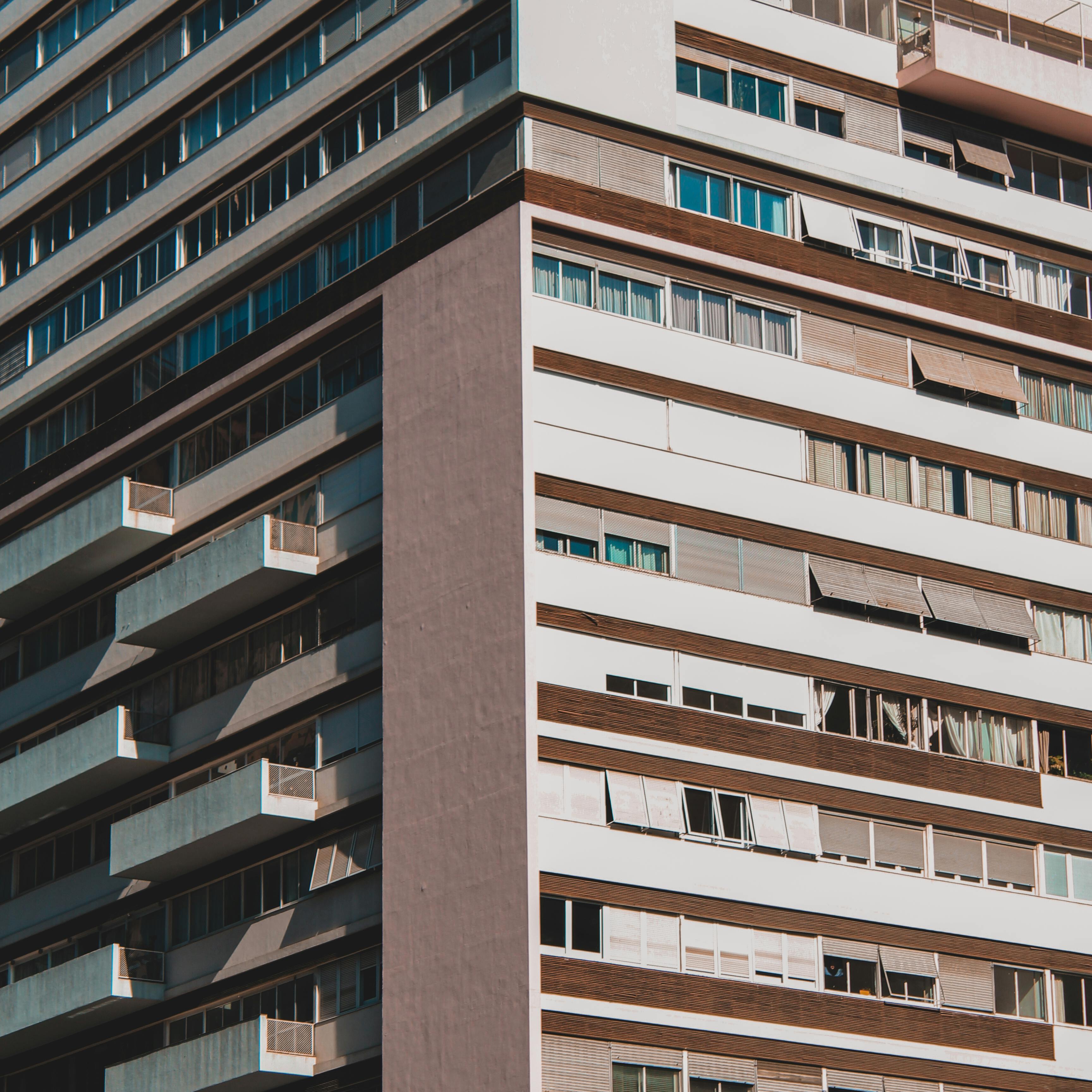 Close-up of a contemporary high-rise building facade with balconies and windows.