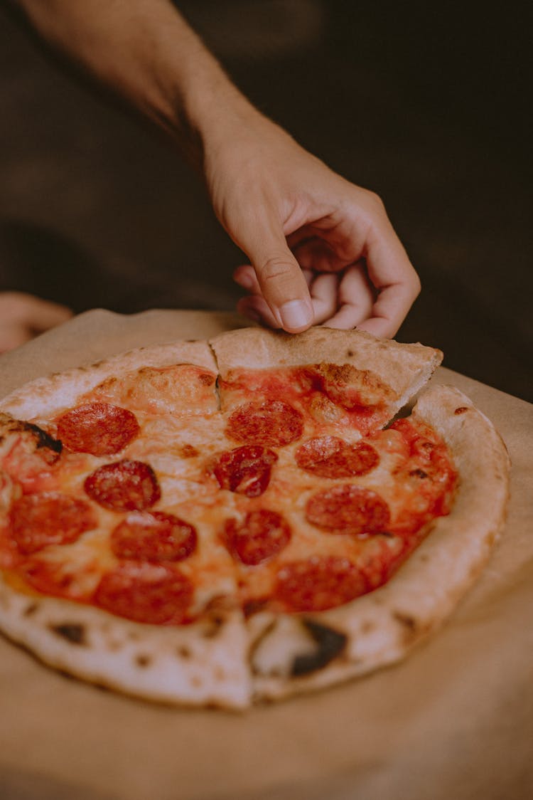 Person Takes A Piece Of Pizza