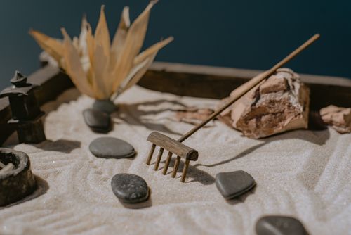 Free Close-up of a Zen garden with sand, stones, and a miniature rake for meditation. Stock Photo