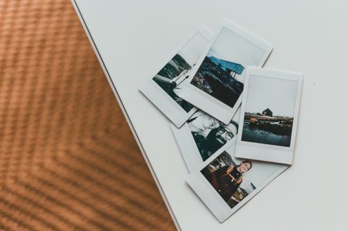 Free A collection of Polaroid photos creatively arranged on a modern table. Stock Photo
