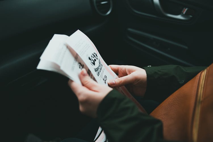 Photo Of A Person Holding Tickets